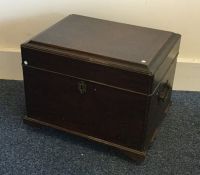 A Georgian oak hinged top trunk with brass handles