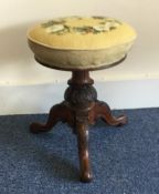 A Victorian tapestry topped stool. Est. £25 - £35.