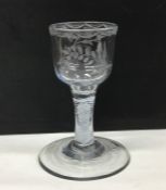 An opaque twist wine glass engraved with flowers a