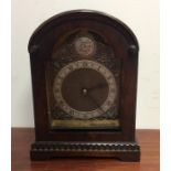 A Georgian style mahogany mantle clock with silver