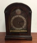 A Georgian style mahogany mantle clock with silver