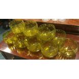 A set of twelve yellow glass dessert dishes with s