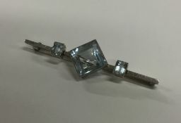 An unusual 18 carat white gold blue stone brooch i