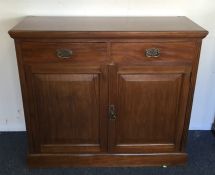 An Edwardian mahogany two drawer and two door side