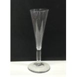 A tall tapering Georgian wine glass on sweeping pe