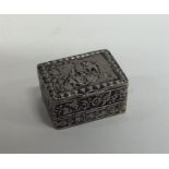 A small hinged top silver pill box decorated with