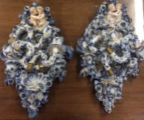 A pair of large blue and white china wall mounts.