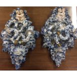 A pair of large blue and white china wall mounts.