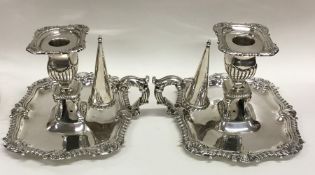 A fine pair of George III silver chamber sticks wi