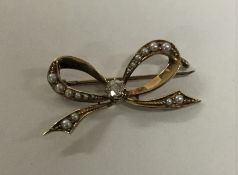 A small 15 carat gold diamond and pearl brooch. Ap