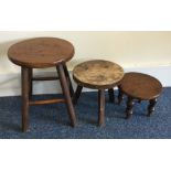 Three small milking stools. Est. £10 - £20.