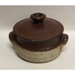 A partially glazed lidded stoneware pottery soup t