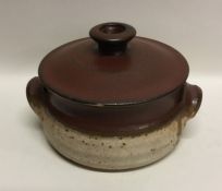 A partially glazed lidded stoneware pottery soup t