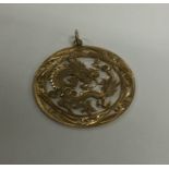 A Chinese 14 carat gold dragon pendant with loop t
