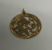 A Chinese 14 carat gold dragon pendant with loop t