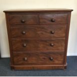 A mahogany chest of five drawers with shaped rims.
