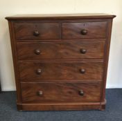 A mahogany chest of five drawers with shaped rims.