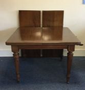A good Edwardian mahogany extending table on taper