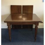 A good Edwardian mahogany extending table on taper