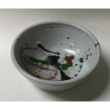 A small stoneware pottery bowl of textured form wi