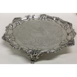 A heavy Victorian silver salver decorated with flo