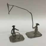 A pair of miniature figures of Dutchmen on square