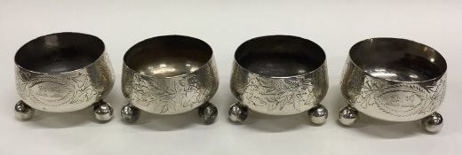 A heavy set of four Victorian silver salts on ball