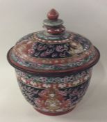 A Chinese tapering bowl and cover decorated in bri