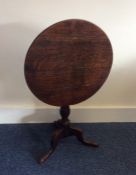 A Georgian oak pedestal table on three sweeping su