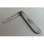 A silver and MOP fruit knife with hinged decoratio