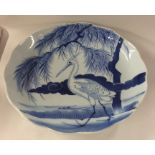 A Chinese blue and white wall charger decorated wi