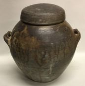 A large ovoid shaped smoke-fired lidded stoneware