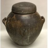 A large ovoid shaped smoke-fired lidded stoneware