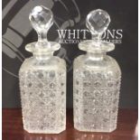 A pair of square cut glass decanters with stoppers