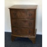 A bow front chest of three drawers to bracket feet