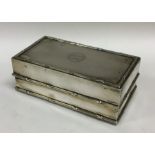 A silver mounted hinged top jewellery box with lea
