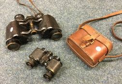 A pair of old binoculars etc. Est. £20 - £30.