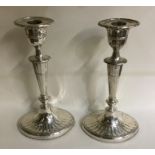 A pair of Edwardian silver tapering candlesticks o