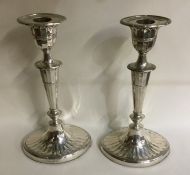 A pair of Edwardian silver tapering candlesticks o