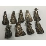 A group of nine miniature silver figures. Approx.