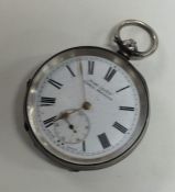 A silver open faced pocket watch with white enamel
