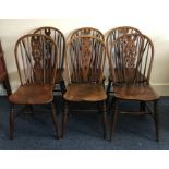 A set of six oak stick back chairs of typical form