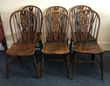 A set of six oak stick back chairs of typical form