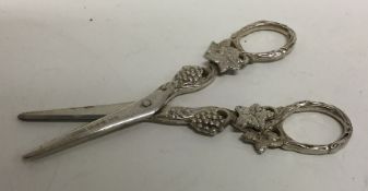 A pair of scroll decorated silver grape scissors d