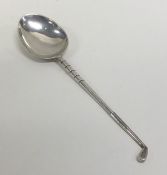 An Edwardian silver spoon in the form of a golf cl