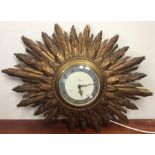 A Smiths sunburst design electric wall clock with