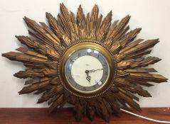 A Smiths sunburst design electric wall clock with