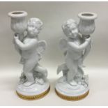 An attractive pair of gilded candlesticks mounted