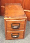 An oak two drawer stationery chest. Est. £20 - £30