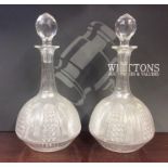 A pair of attractive cut glass decanters with reed